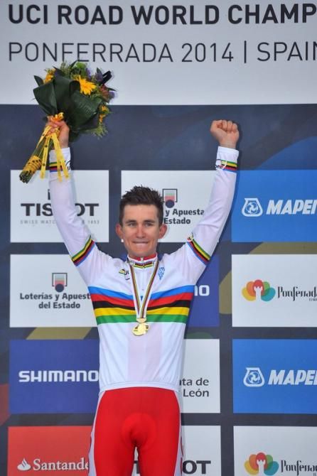 Michal Kwiatkowski (Poland) raises his arm after being presented with the rainbow jersey
