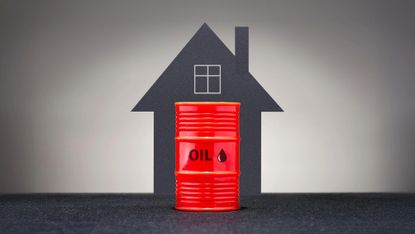 Graphic showing red barrel of oil in front of a grey background and the outline of a house. 