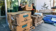 Workers in Turkey load medical supplies for shipment to Iran. 