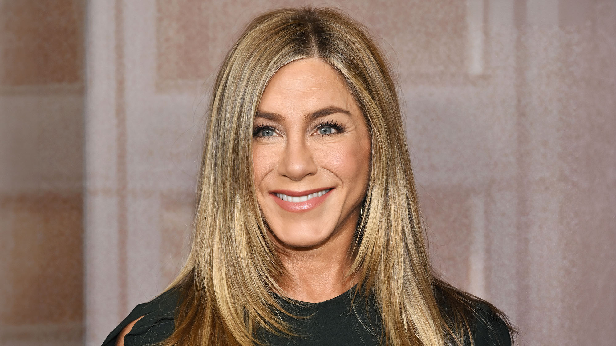 Jennifer Aniston at "The Morning Show" Season 4 Official Emmy FYC Event wearing black stood in front of neutral background