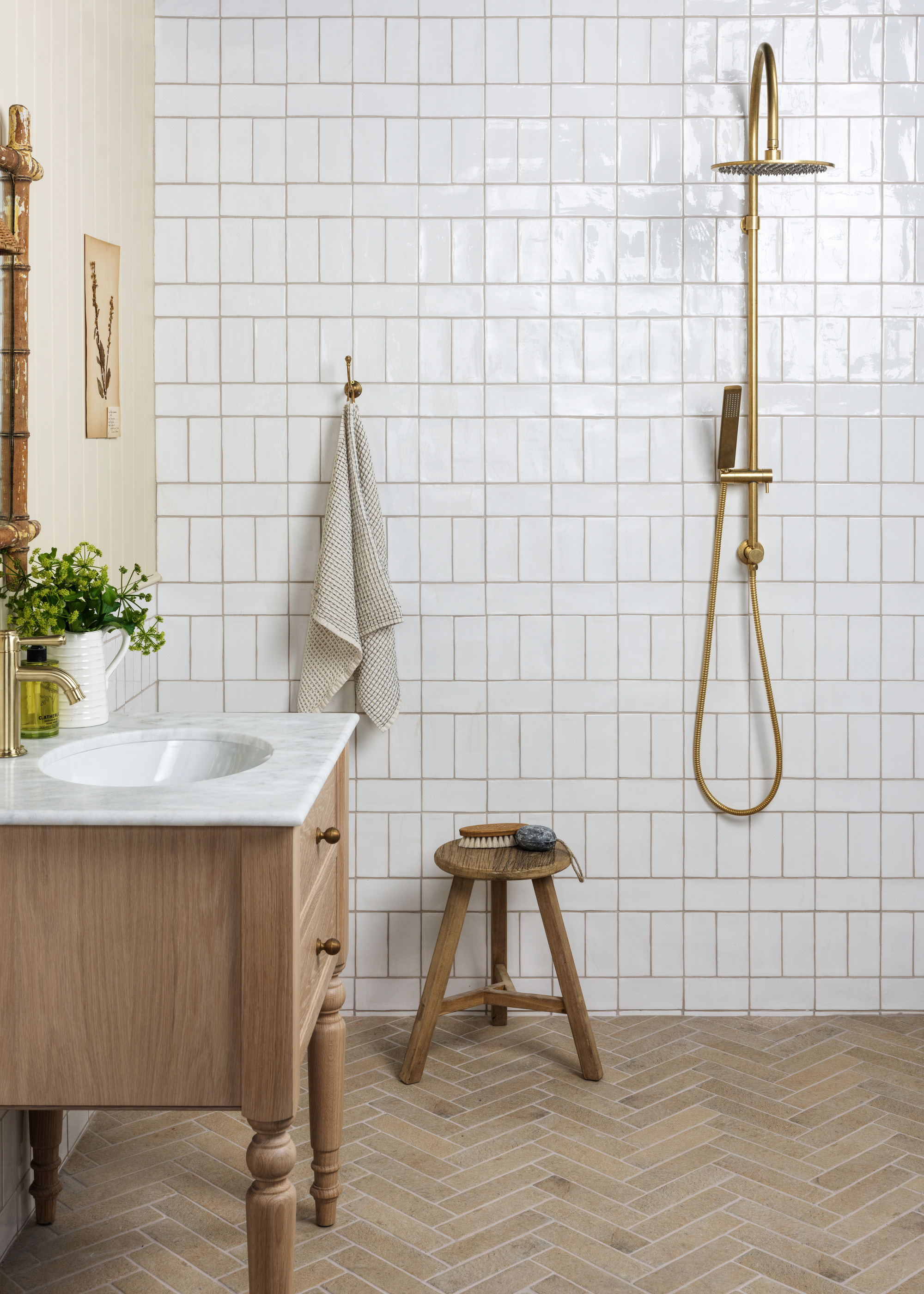 Shower room with white wall tiles and a brass shower