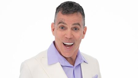 A close up of Steve-O smiling in front of a white background