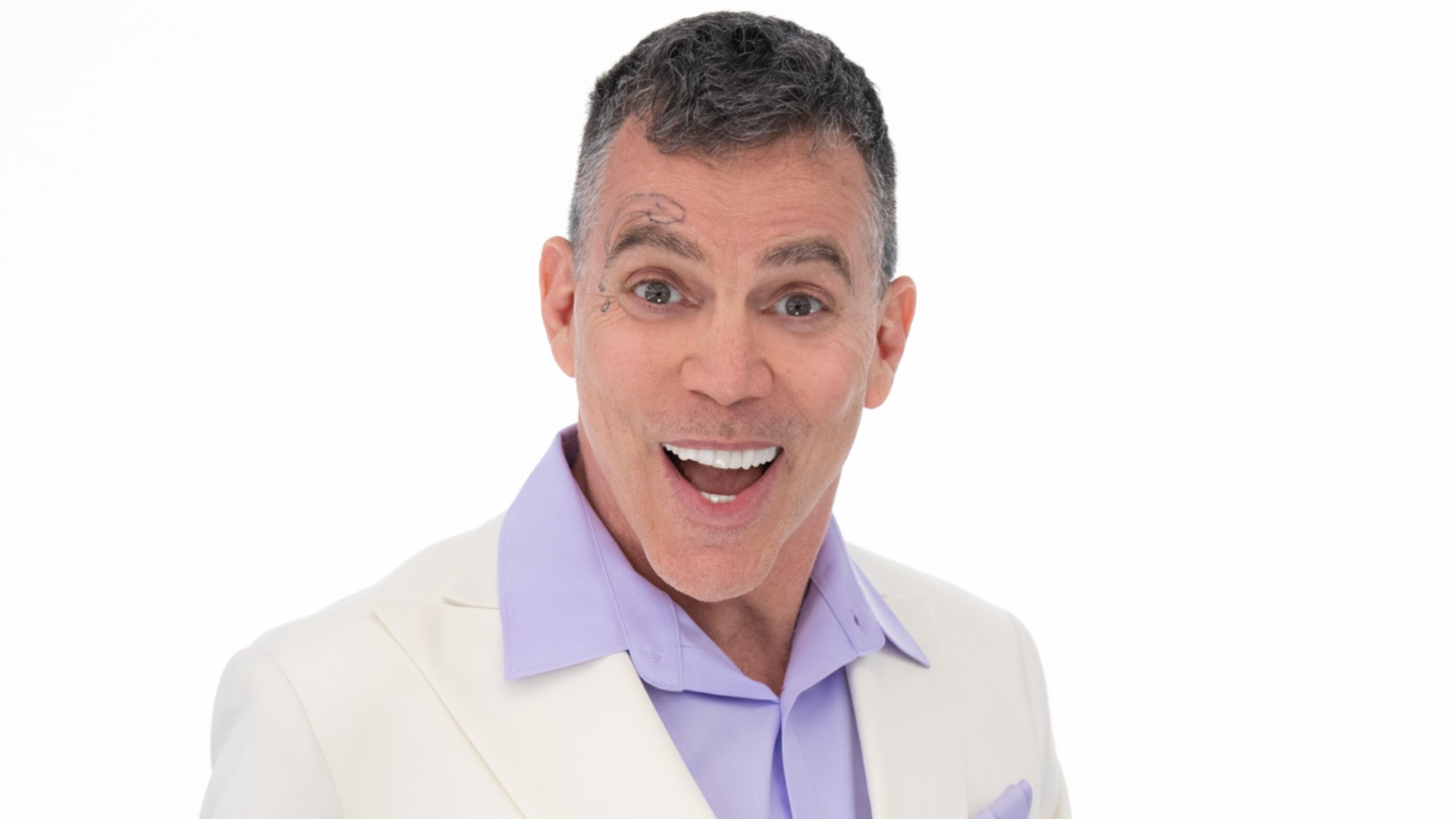 A close up of Steve-O smiling in front of a white background