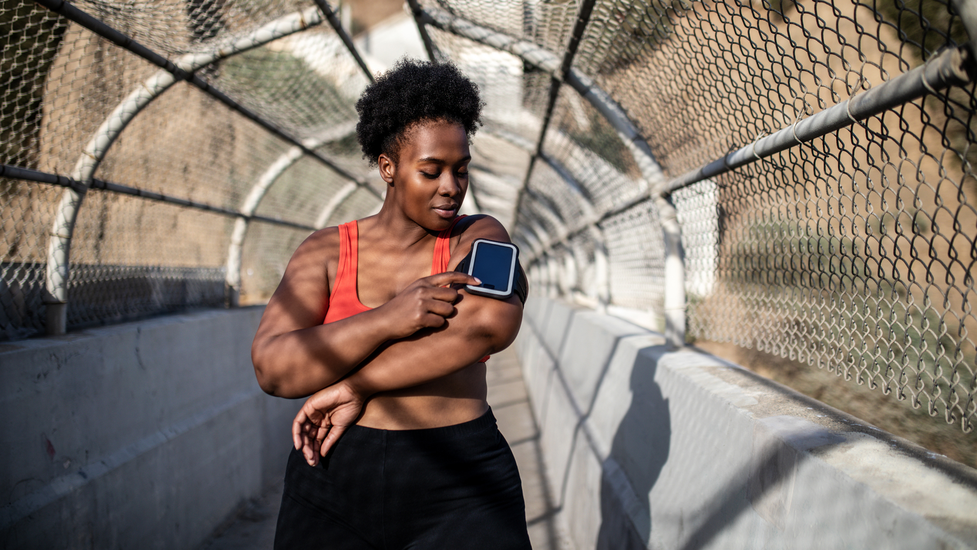 Image of woman checking fitnss tracker during run