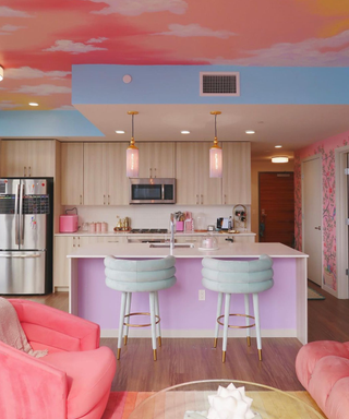 A colorful apartment with blue, purple, and pink tones and a sky ceiling mural