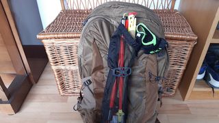 Osprey Talon Earth 22 fully packed with hiking poles