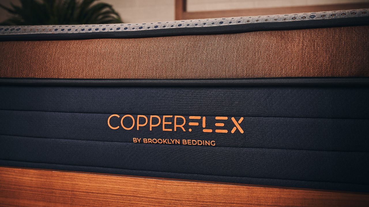 Navy and bronze side panel of Brooklyn Bedding Copperflex Memory Foam Mattress with logo