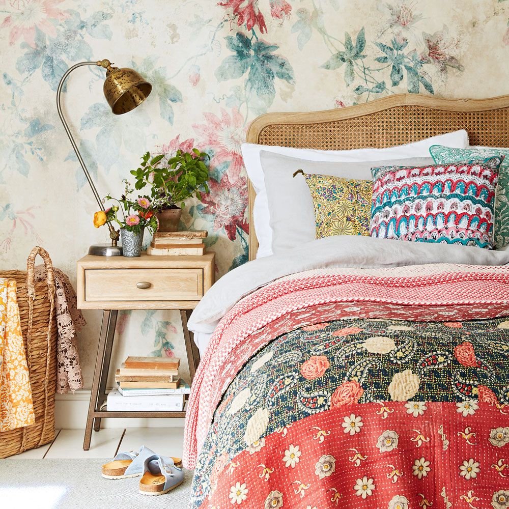 bedroom with floral wallpaper and bed linen