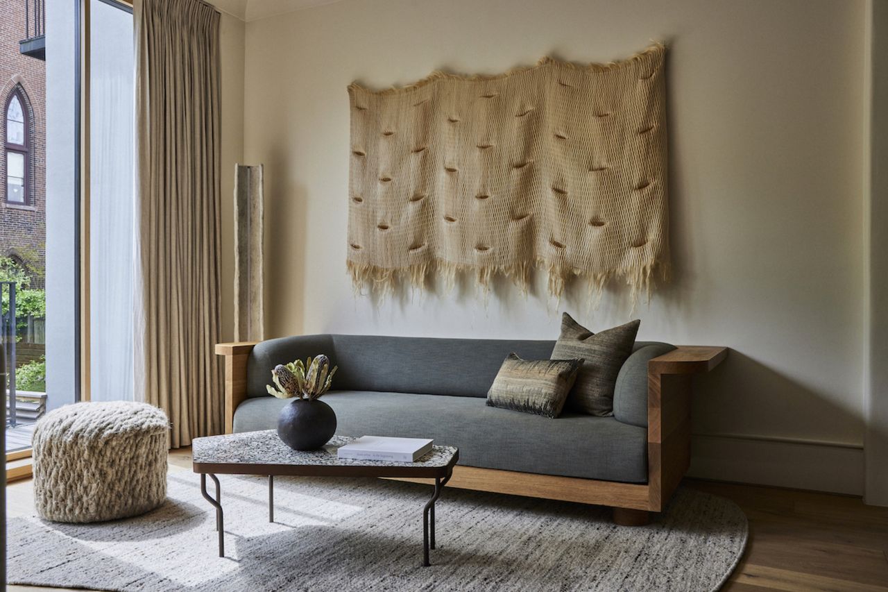 A living room with wall tapestry