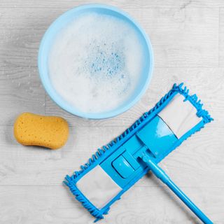 Blue mop and bucket on hard flooring