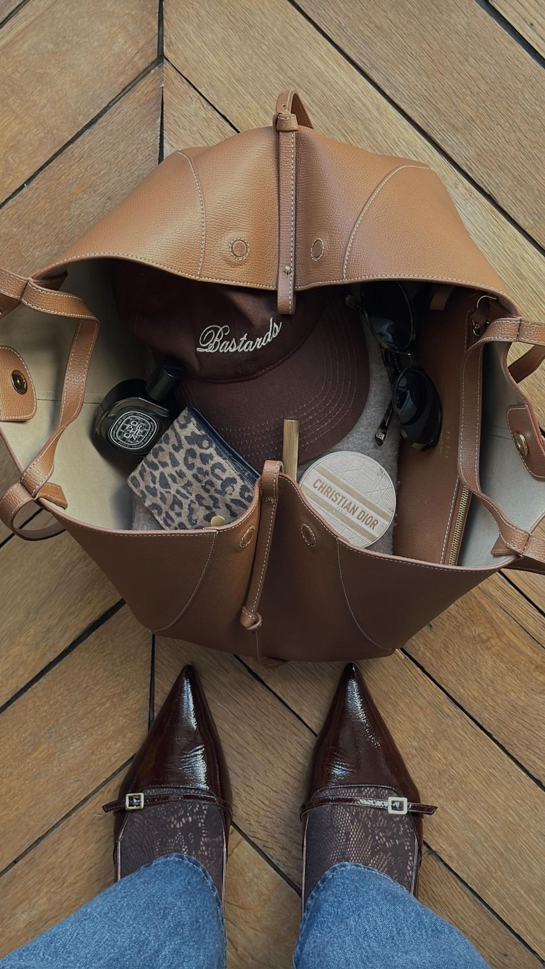 Open bag with cap, perfume, makeup inside