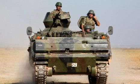 Turkish soldiers patrol the Turkey-Syrian border on Oct. 4