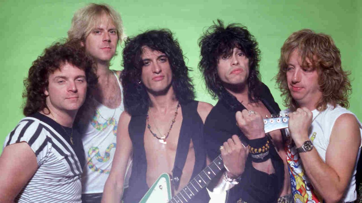 Aerosmith posing for a photograph against a bright green background in 1984 