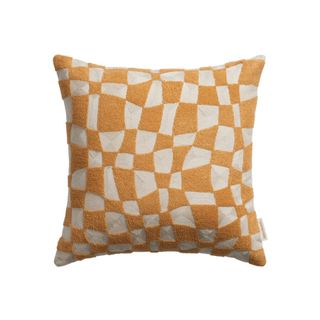 A broken checked pillow in yellow and cream