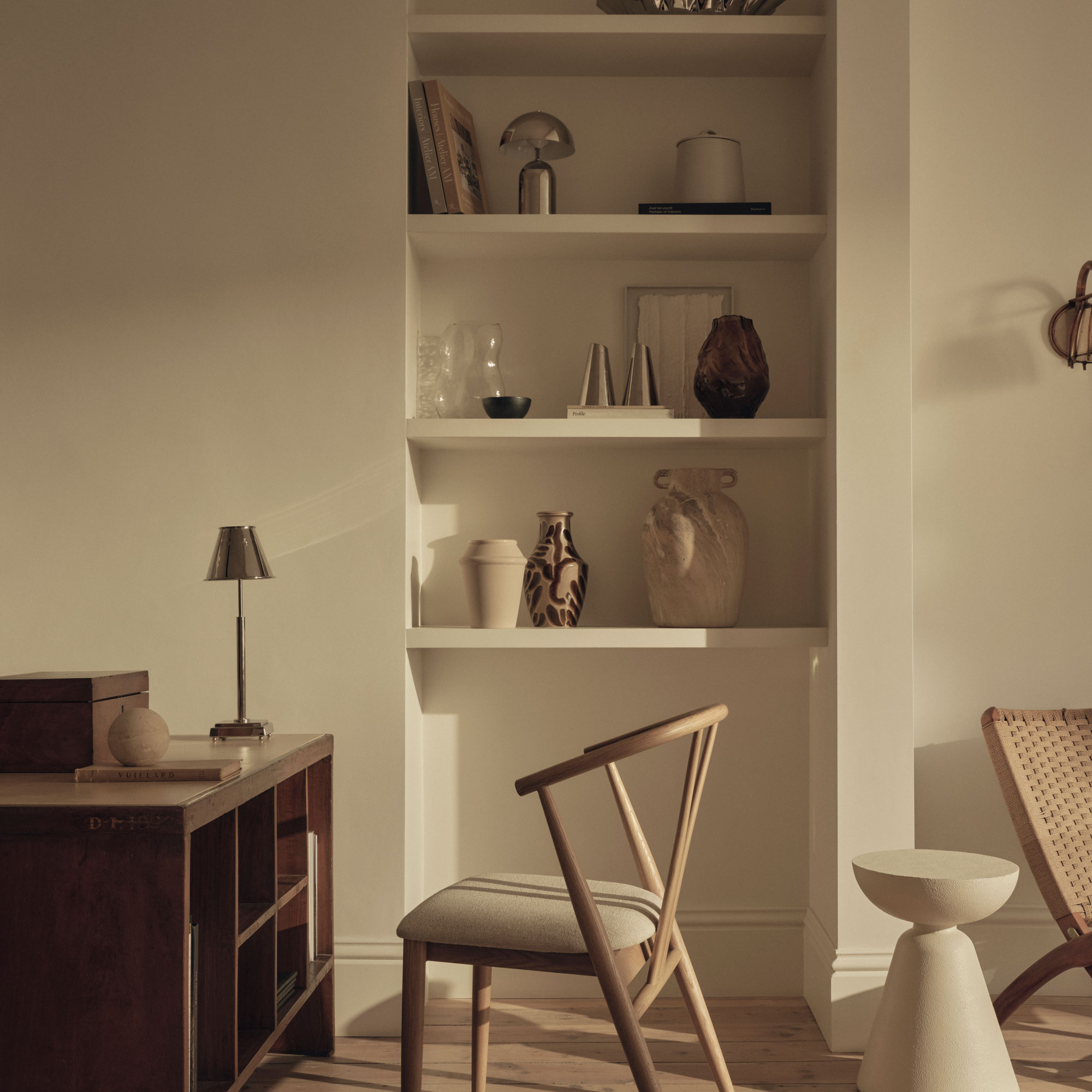 Beige colour scheme with built in shelves and chrome lighting on shelves