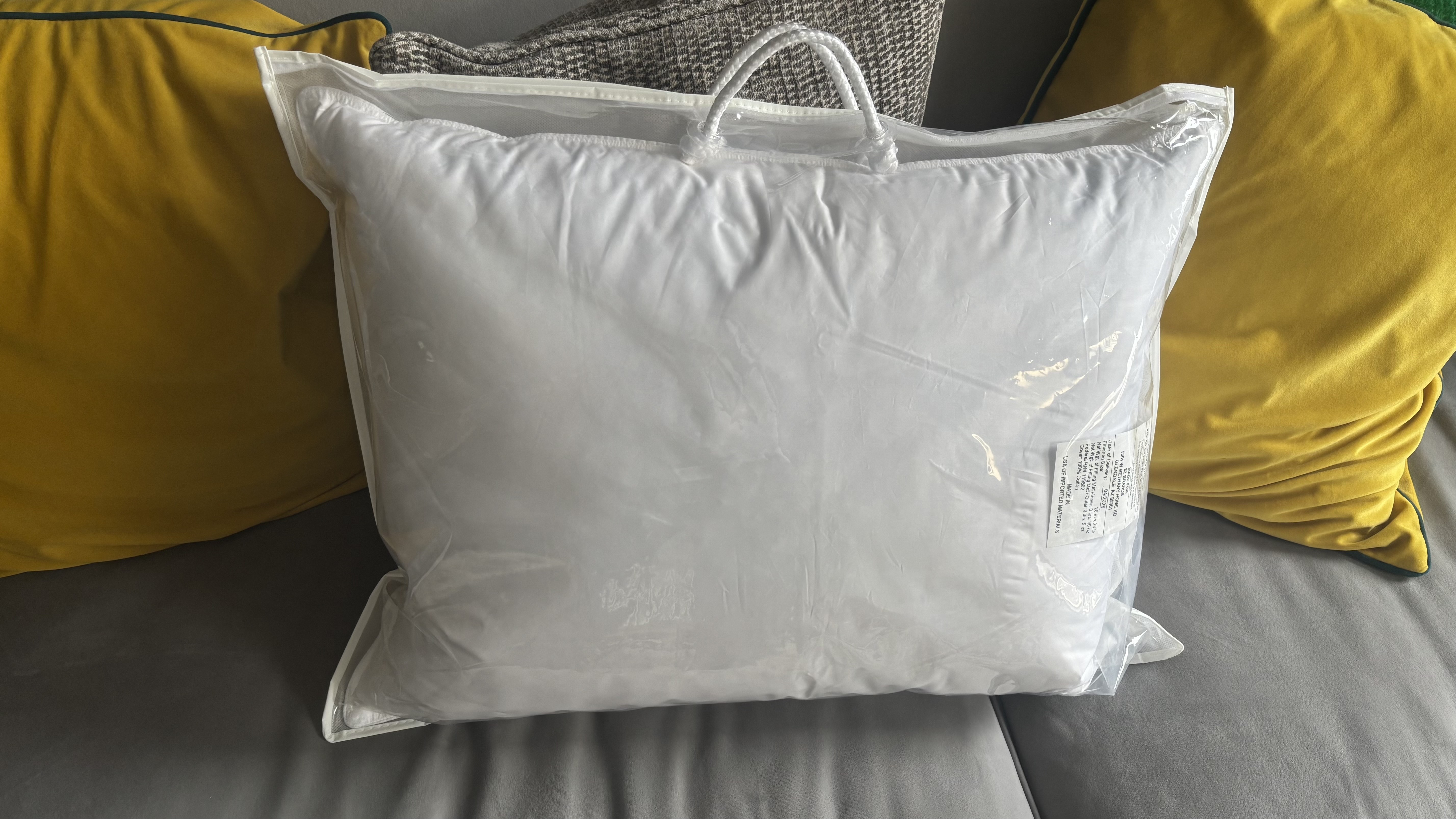 The Helix Down &amp;amp; Feather Pillow unboxed but still in its plastic packaging.