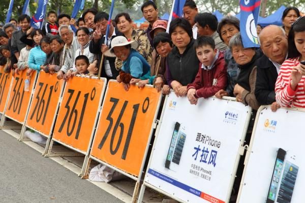 Locals wait for the race in the finish area.