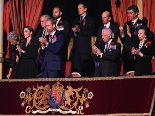 Princess Anne, King Charles, Prince William, Princess Kate and other royals standing and clapping in the royal box at the Festival of Remembrance.