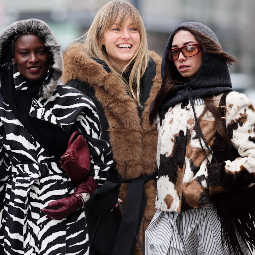 guests at Copenhagen Fashion Week wearing colorful and animal print coats in street style