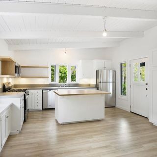 kitchen with white wall and fridge