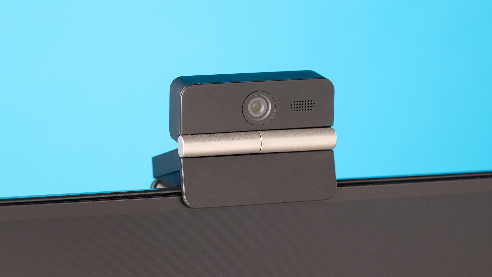 Obsbot Meet Flip foldable webcam photographed in front of a blue background