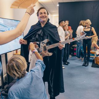 Noe Efira with Veleno guitar backstage at the Olympics