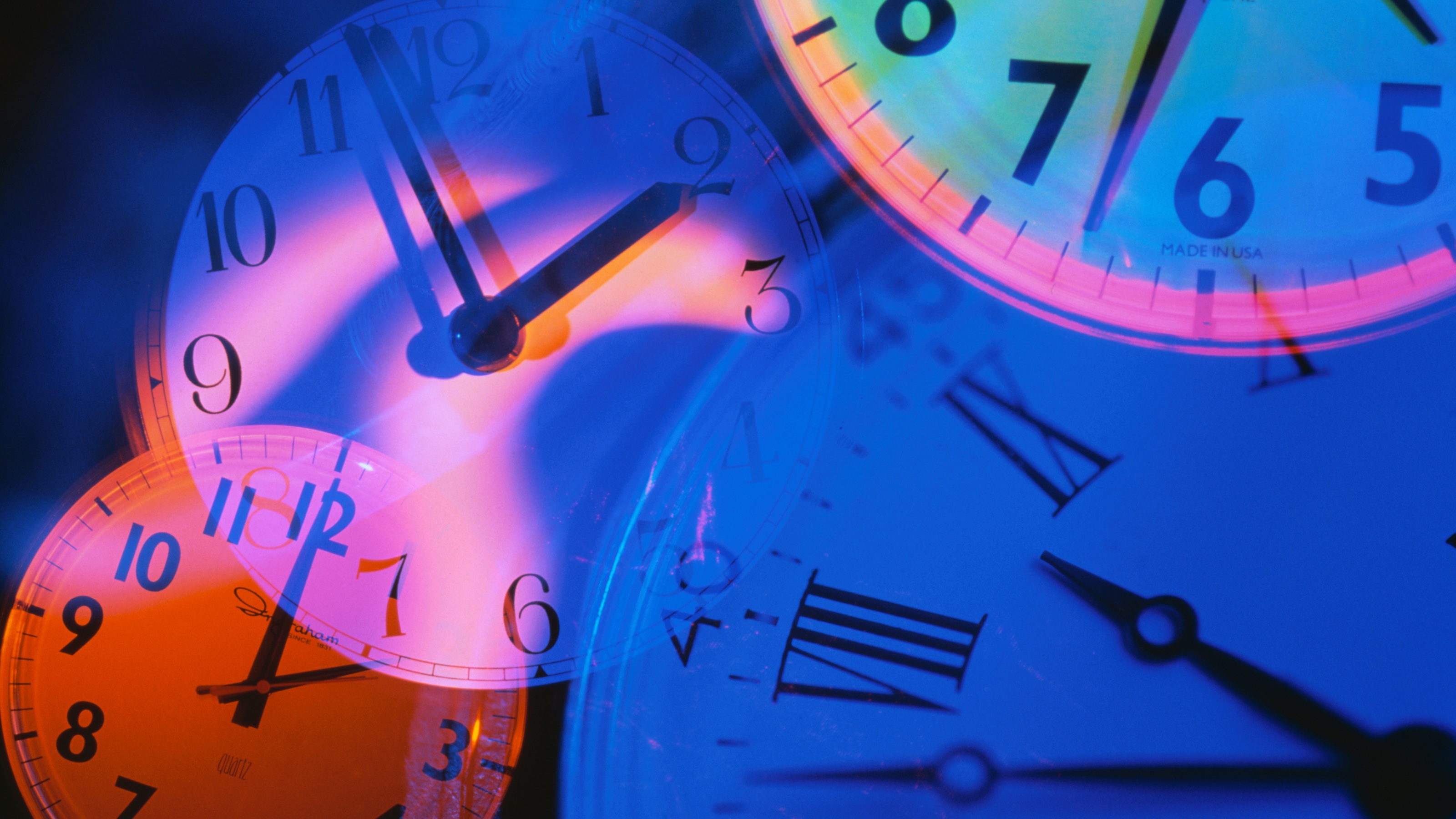 Several different clock faces set at difference times.