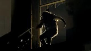 A werewolf leaping through a window in The Wolfman