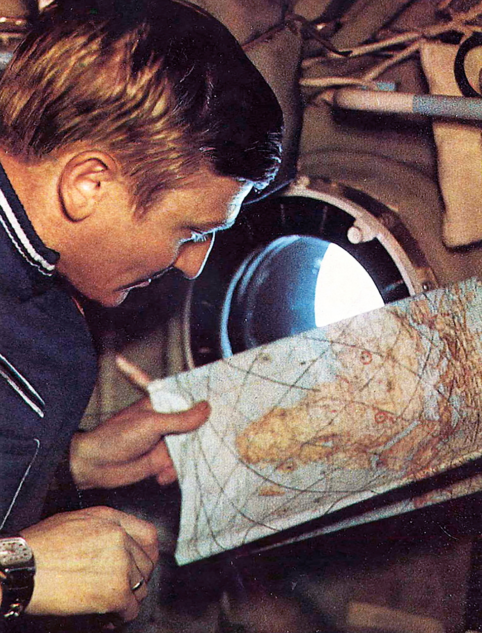 Mirosław Hermaszewski uses a map while performing observations of Earth aboard the Salyut 6 space station in 1978.