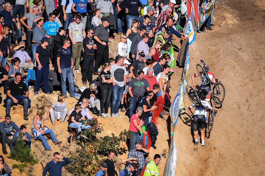 The two leaders running up the sandhill with the fans cheering them on