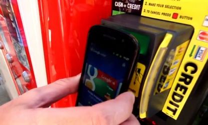 A man buys a vending machine soda using Google Wallet: Paying with your smartphone may become the norm in just eight years time.