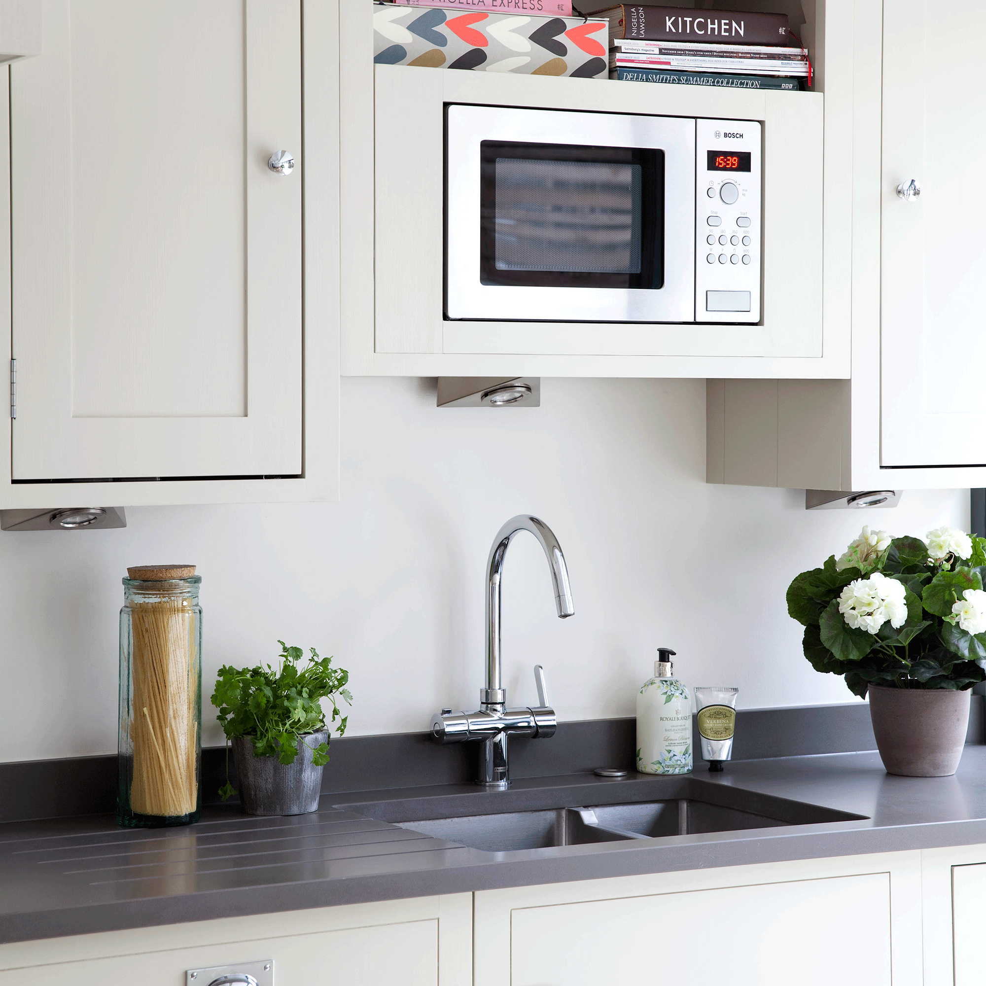 White kitchen with sink and microwave