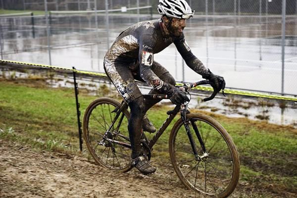 Jake Wells (Mafia Racing) hugs the course tape in search of a fast line through the mud.