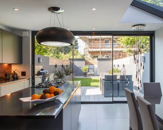 A modern kitchen installed with IDSystems' aluminium sliding doors
