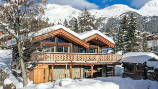 A snow topped ski chalet in a valley