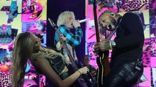 Guitarist Sophie Lloyd, Machine Gun Kelly and guitarist Justin Lyons perform onstage at the 2023 Sports Illustrated Super Bowl Party at Talking Stick Resort early on February 12, 2023 in Scottsdale, Arizona.