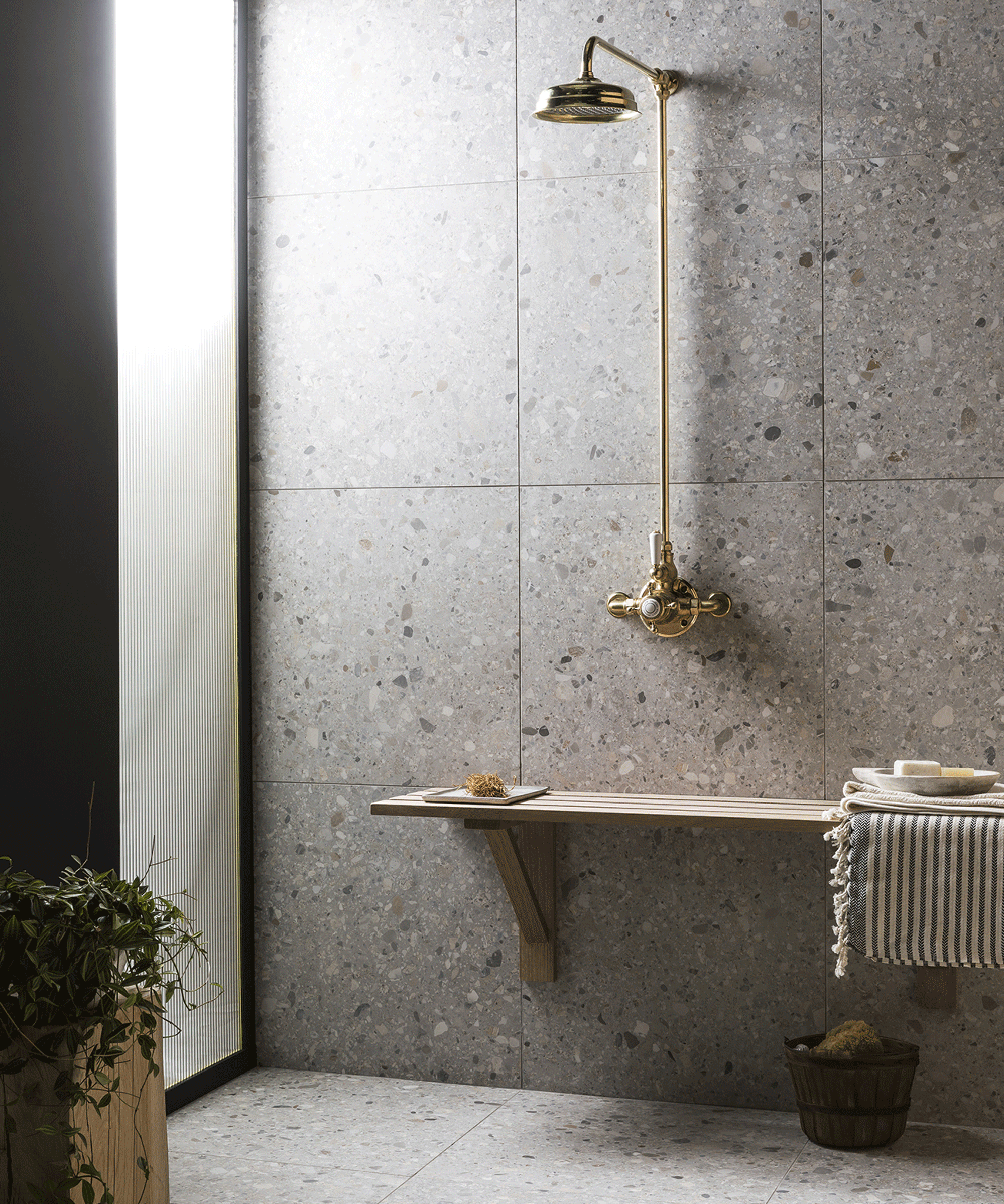 Wet room with minimal design, gold effect shower, wooden bench, floor and wall tiles