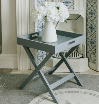 carpet floor with tray table and flower jug