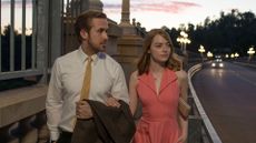 Ryan Gosling walks Emma Stone down a bridge in La La Land 