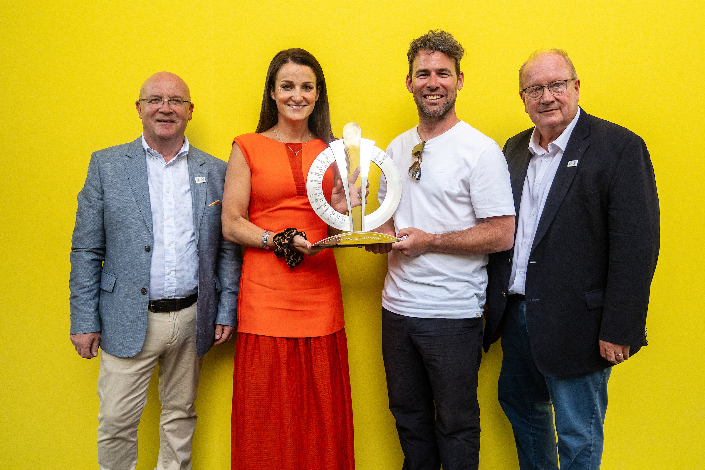 Lizzie Deignan and Mark Cavendish pose with the organisers of the Grand Depart UK 2027