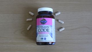 Container of Garden of Life Vitamin Code 50 and Wiser Women on a table