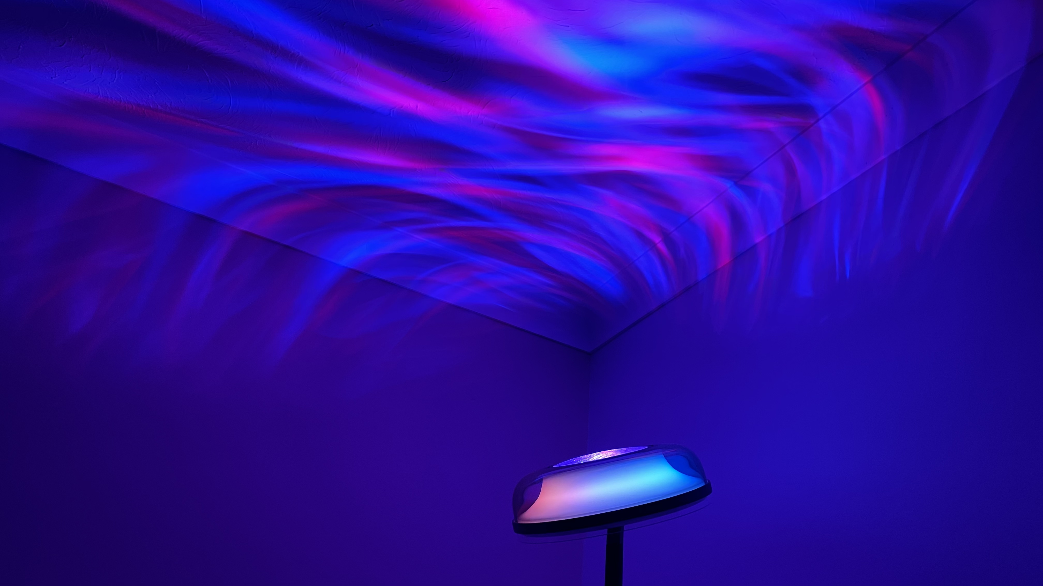 The Govee Uplighter is projecting ripples of blue and pink onto the ceiling.