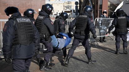 A protester being detained by police in Moscow’s Manezhnaya Square