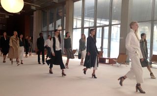 Models walking, wearing coats and heels