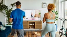 Man and woman complete a home workout