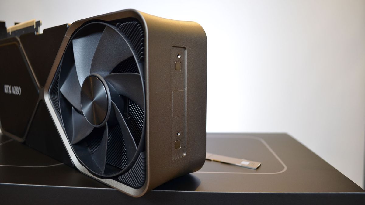 An Nvidia GeForce RTX 4080 on a wooden desk in front of a white panel