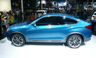 Blue BMW X4 concept car on display at a car show