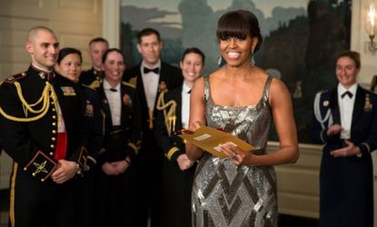 The first lady opens the envelope holding the name of the Best Picture winner.