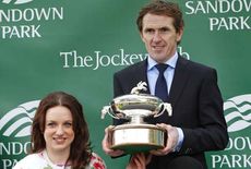 AP McCoy receives a trophy from Natasha Baker