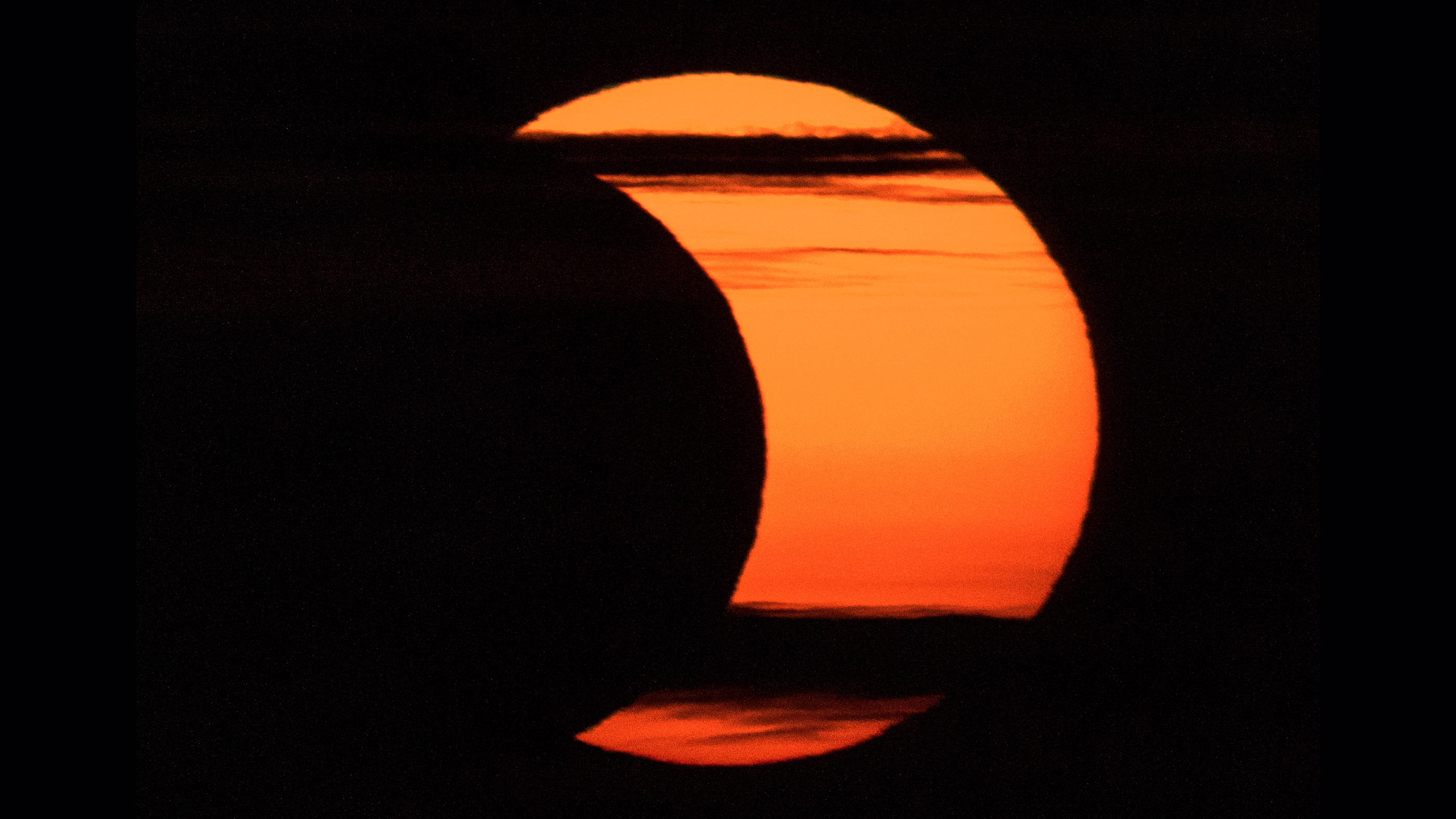 A partial solar eclipse is seen from Arlington, Virginia, Thursday, June 10, 2021.